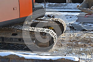 Closeup Continuous tracks or Tracked wheel of excavator or backhoe on the soil floor