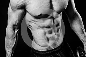 Closeup of cool perfect strong sensual bare torso with abs pectorals 6 pack muscles chest black and white studio