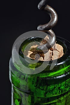 Closeup corkscrew and wine bottle photo