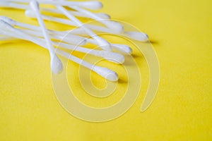 Closeup of cotton buds, in soft focus,  on yellow background