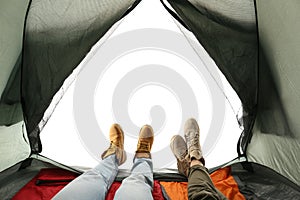 Closeup of couple in camping tent on white, view from inside