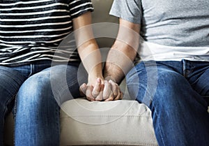 Closeup of couple holding hands together