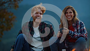 Closeup couple laugh outdoors together in mountains. Family enjoy time on nature.