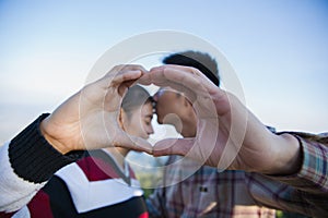 Closeup of couple making heart shape with hands, Happy in love
