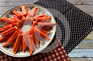 Closeup crab stick in dish on table background