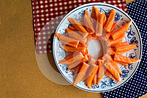 Closeup crab stick in dish on table background