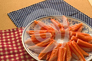 Closeup crab stick in dish on table background