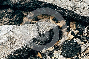 Closeup of cracked asphalt concrete road