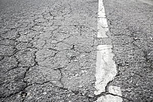 Closeup of cracked asphalt road