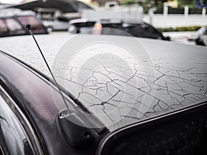 Closeup of cracked and peeling paint on an old car, old abandoned aged weathered automobile car color cracked rustic and dirty as