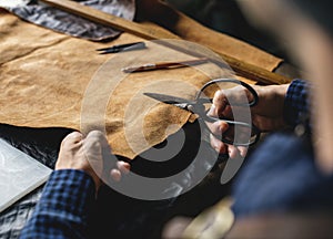 Closeup of craftsman cutting leather handicraft