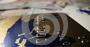 Closeup of credit card and currency banknotes on table