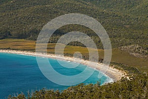 Closeup of crescent turquoise waters of Wineglass Bay white sand