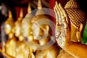 Closeup and crop hand of golden Buddha statue