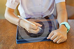 Closeup and crop hands of Student using and study on tablet at school