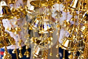 Small golden bells was hung in a group in Thai temple.