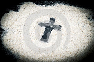 Closeup of cross symbol on the sand