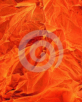 A closeup of crushed paper in orange.