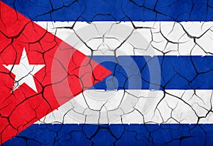 Closeup of cuban flag broken crack wall with rift, communist dictatorship