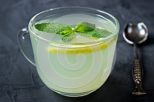 Closeup of Cup of Ginger tea with lemon and mint