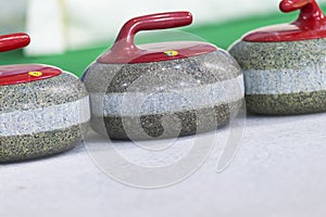 Closeup of Curling Blue Handle Stones on Ice.With Copyspace