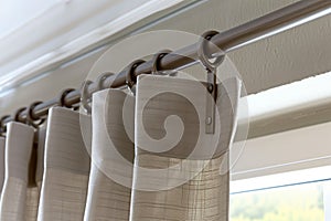 closeup of a curtain rod with a builtin track and sliders