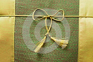Closeup of cushion with ribbon