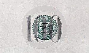 Closeup of cut number 100 of dollar bill on white background