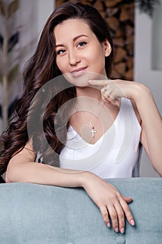 Closeup cute beautiful brunette girl with long hair in silver jewelry earrings and necklace. Ð¡oncept of gentle, elegant, delicate