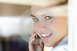 Closeup of a cute female talking over the cellphone. Closeup of a cute young woman speaking over the cellphone.