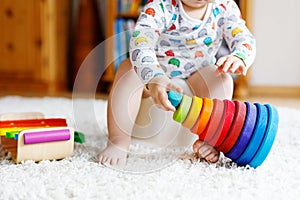 Closeup of cute little 12 months old toddler baby girl child sitting on potty.