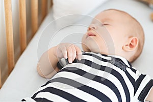 Closeup of cute newborn baby sleeping in his cradle