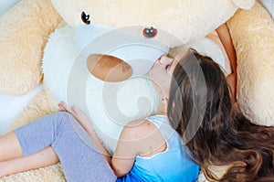 Closeup of cute sad little girl near the teddy bear. Varicella virus or Chickenpox bubble rash on child