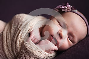 Closeup infant baby girl sleeping at background. Newborn and mothercare concept photo