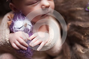 Closeup Infant baby girl sleeping at background. Newborn and mothercare concept photo