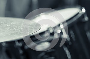 Closeup cymbal with drumkit partly visible blurry background, studio equipment concept