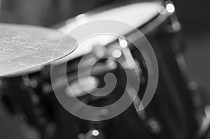 Closeup cymbal with drumkit partly visible blurry background, studio equipment concept