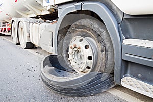 Closeup damaged 18 wheeler semi truck burst tires by highway str