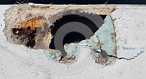 Closeup of a damaged fiberglass boat photo