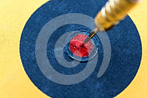 Closeup dart hitting on bullseye target