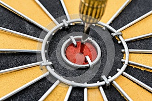 Closeup dart target with arrow on bullseye