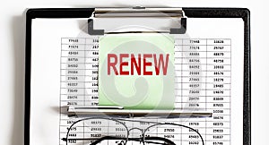 Closeup of the deadline time of RENEW and glasses and pen