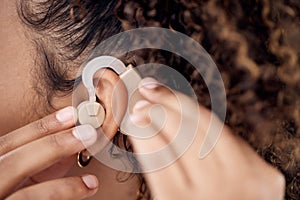 Closeup, deaf and woman with cochlear implant for hearing, audio and aid for disability or impairment. Sound, hands and