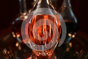 Closeup of decanters on silver tray.