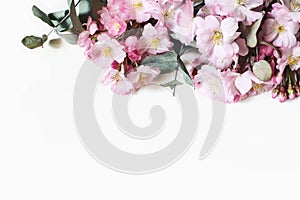 Closeup of decorative banner made of pink Japanese cherry blossoms and eucalyptus branches. Styled stock photo. Spring