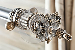 closeup of a decorative curtain rod with elaborate ends