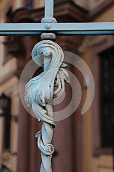 A closeup of a decorative detail of a metalwork fence