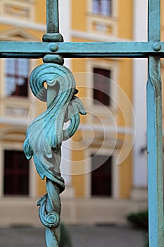 A closeup of a decorative detail of a metalwork fence