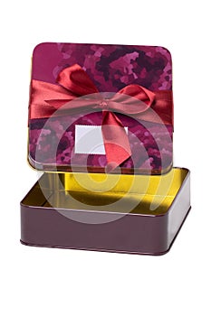 Closeup of a decorative opened red pink present or gift box with ribbon bow isolated on a white background. Birthday, Christmas,