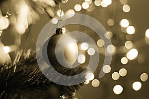Closeup of a decorative ornament hanging from the Christmas tree covered with lights
